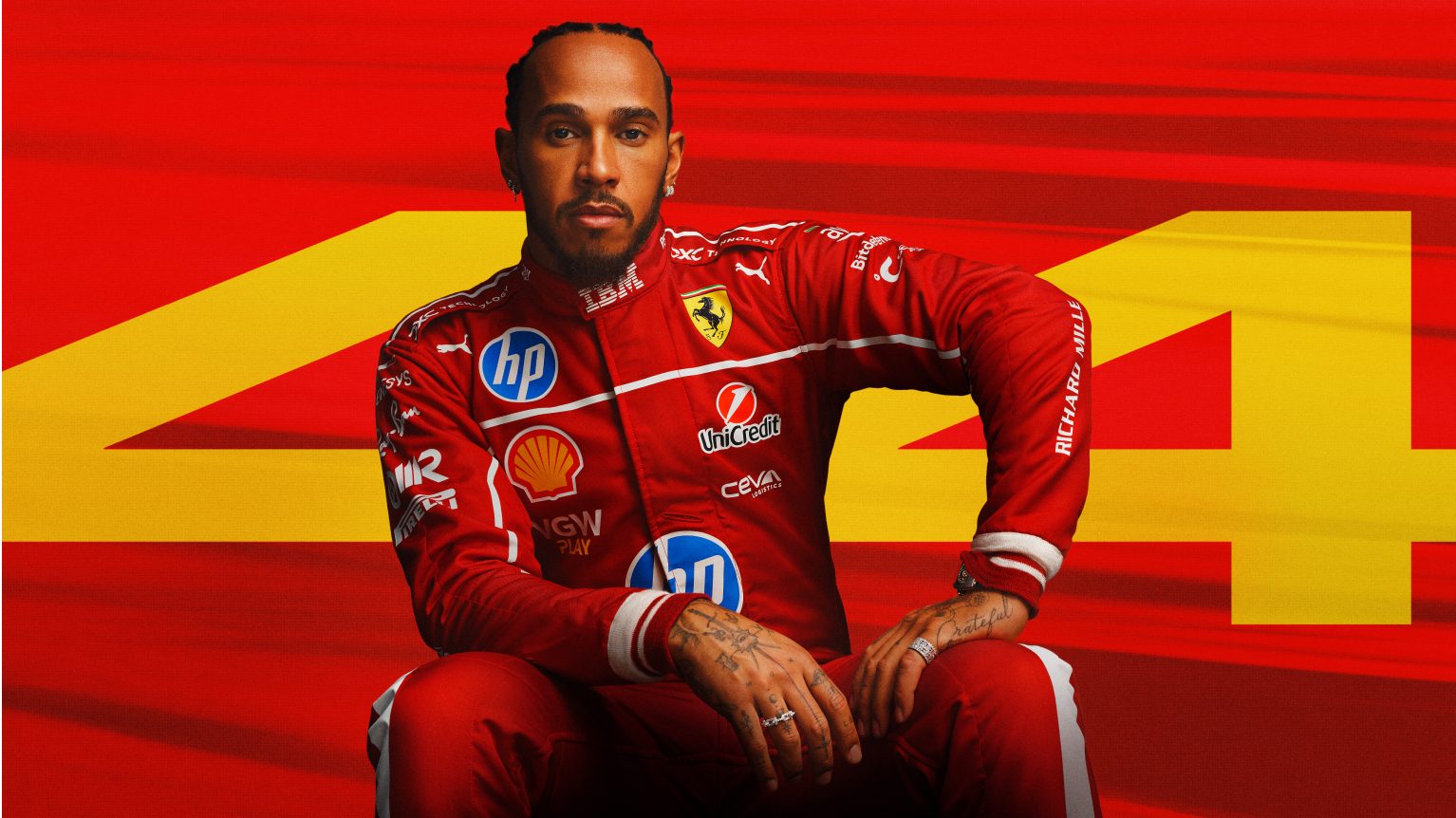 Lewis Hamilton sat in front of a red background with the numbers "44" present.